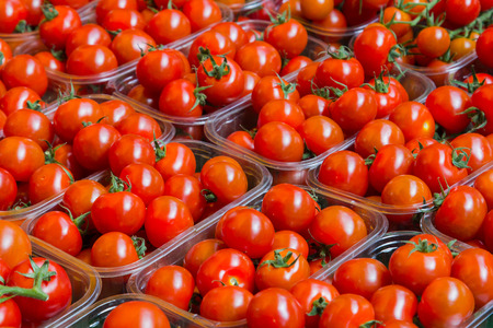 Fresh Tomatoes on display at a marketの写真素材