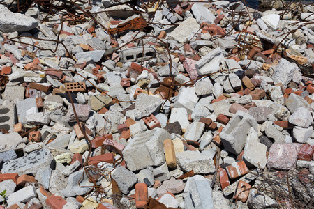 Pile of rubble with tangled metal wire and bricks