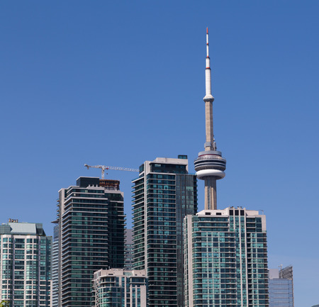 TORONTO, CANADA - 10 AUGUST 2014  The CN Tower sticking up behind modern condos in downtown Torontoのeditorial素材