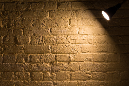 A spot light shining on a wall with copy spaceの写真素材