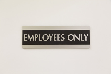 A sign saying Employees only