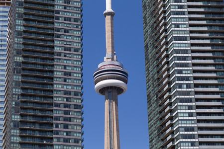 TORONTO, CANADA - 10TH AUGUST 2014: The CN Tower showing between condos in downtown Toronto during the dayのeditorial素材