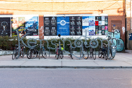 TORONTO, CANADA - 2ND NOVEMBER 2014: A sign for Kensington in Toronto. Bikes can be seen attached to it.のeditorial素材