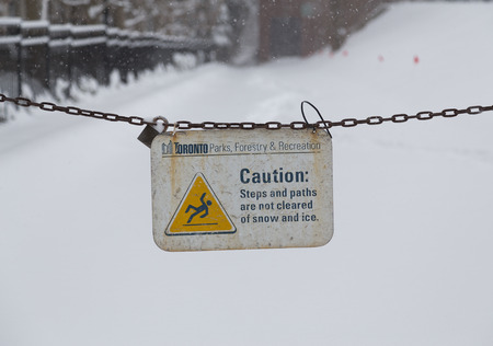TORONTO, CANADA - 11TH DECEMBER 2014: A sign towards the entrance of a Park in Toronto warning...