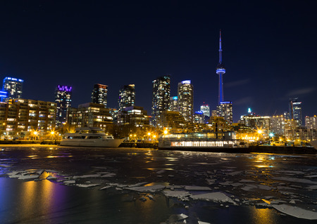TORONTO, CANADA - 12TH JANUARY 2015: Part of the Toronto Skyline in the winter showing frozen water in the lakeのeditorial素材