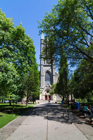 TORONTO, CANADA - 22ND JUNE 2014: The outside of the Metropolitan United Church during the day. Lots of people can be seen outside on benchesのeditorial素材