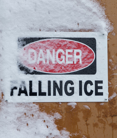 TORONTO, CANADA - 22ND FEBRUARY 2015: A closeup to a Danger Falling Ice Sign during the dayの写真素材