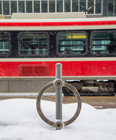 TORONTO, CANADA - 22ND FEBRUARY 2015: A Toronto Streetcar and Bike Lock during the winterのeditorial素材
