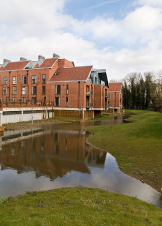 BUCKINGHAM, UK - 6TH MARCH 2015:  Water that has come from the River Great Ouse in Buckingham. Showing the water near houses.のeditorial素材