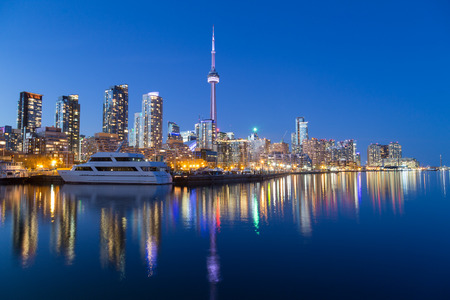 TORONTO, CANADA - 16TH APRIL 2015: A view of Toronto downtown at dusk showing buildings, condos, the CN Tower and boats.のeditorial素材