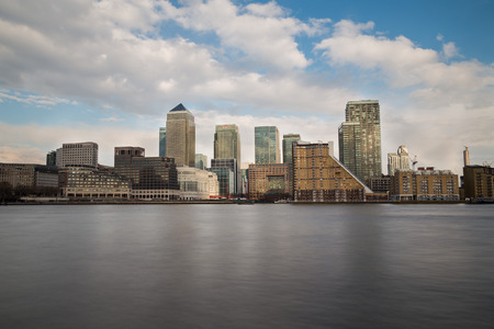 LONDON, UK - 24TH MARCH 2015:  Canary Wharf during the day from across the River Thames, showing office and residential buildings.のeditorial素材