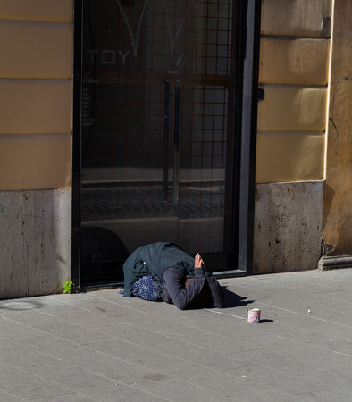 ROME, ITALY - 12TH MARCH 2015: A lady begging for money outside on a street in Romeのeditorial素材