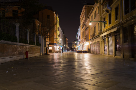 VENICE, ITALY - 13TH MARCH 2015: Strada Nuova in Venice at night, showing shops, restaurants and the blur of people walkingのeditorial素材