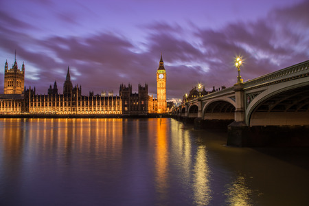 Houses of Parliament from across the River Thames at dusk. Part of Westminster Bridge can be seen.のeditorial素材