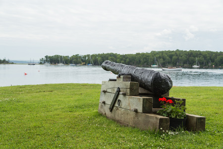 BADDECK, CANADA - 5TH JULY 2015: A cannon statue at the Baddeck Waterfront during the day.のeditorial素材