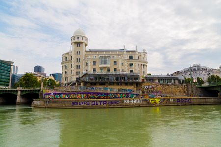 VIENNA, AUSTRIA - 2ND AUGUST 2015: The outside of buildings along the Danube Canal in Vienna during the day. People can be seen.のeditorial素材
