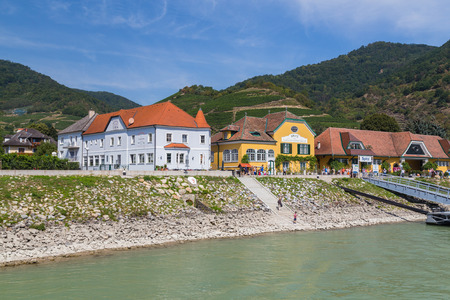 KREMS, AUSTRIA - 28TH AUGUST 2015: Buildings along the waterfront in Krems. People can be seen.のeditorial素材