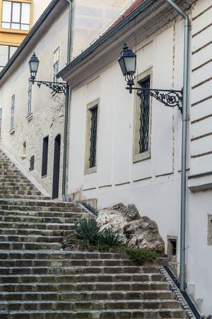 Old Lamps on the outside of buildings on a street in Budapest during the day.の写真素材