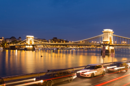 BUDAPEST, HUNGARY - 29TH OCTOBER 2015: The Szechenyi Chain Bridge in Budapest Hungary from the distance at night. Cars can be seen in the foreground.のeditorial素材