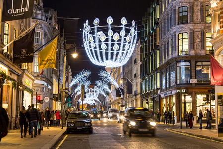 LONDON, UK - 23RD DECEMBER 2015: A view down New Bond Street in London during the Christmas period showing building exteriors, decorations, people and traffic.のeditorial素材