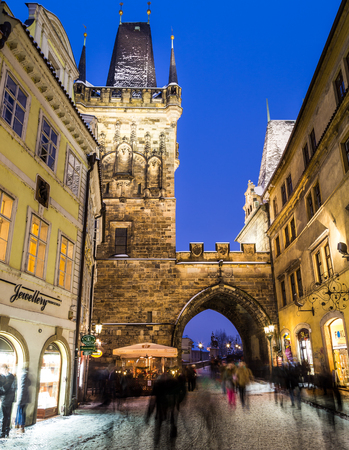 PRAGUE, CZECH REPUBLIC - 6TH JANUARY 2016: A view towards the Tower leading to Charles Bridge in Prague from the Lesser Quarter and Mostecka Street. The blur of people can be seen.のeditorial素材