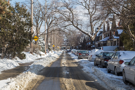 TORONTO, CANADA - 3RD FEBRUARY 2015: A view down streets in Toronto during the winter months. Lots of snow can be seen.のeditorial素材