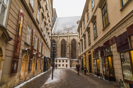 VIENNA, AUSTRIA - 5TH JANUARY 2016: Part of St. Stephen's Cathedral (Stephansdom) in Vienna from Churhausgasse during the winter. Snow can be seen on the building. People can be seen.のeditorial素材