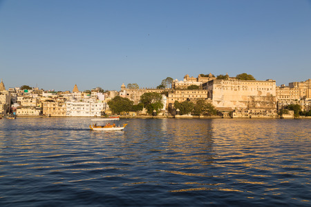 UDAIPUR, INDIA - 20TH MARCH 2016: A view of part of the Udaipur Skyline during the day. Boats, buildings and people can be seen.のeditorial素材