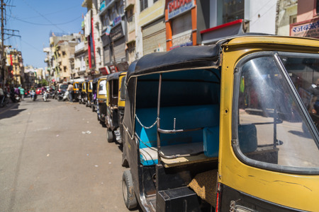 UDAIPUR, INDIA - 20TH MARCH 2016: A queue of Rickshaws in central Udaipur during the day. People can...
