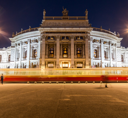 VIENNA, AUSTRIA - 22ND APRIL 2016: The outside of the Burgtheater in Vienna at night. The blur of a tram can be seen going past.のeditorial素材