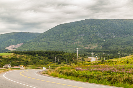 CAPE BRETON, CANADA - 27TH AUGUST 2015: Cape Breton Island in Nova Scotia during the day showing hills and a bendy road.のeditorial素材