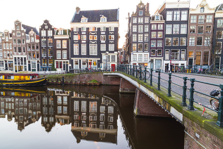 AMSTERDAM, NETHERLANDS - 16TH FEBRUARY 2016: A view of buildings and bridges along the Amsterdam Canals. People can be seen.のeditorial素材