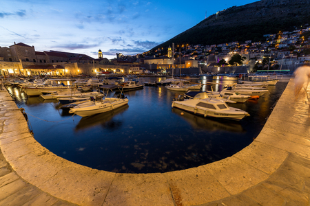 DUBROVNIK, CROATIA - 11TH AUGUST 2016: Boats docked in the Dubrovnik Old Port at dusk.のeditorial素材