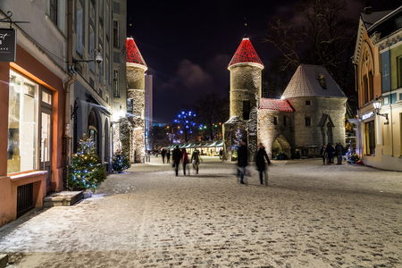 TALLINN, ESTONIA - 3RD JAN 2017: A view along Viru Street towards Viru Gate and Towers at night. The blur of people can be seen.のeditorial素材