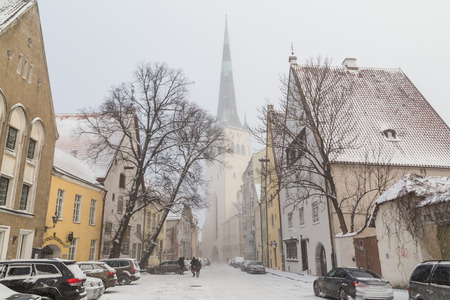 TALLINN, ESTONIA - 5TH JAN 2017: A view towards St Olaf's Church in Tallinn during the day in the winter. People and snow can be seen.のeditorial素材
