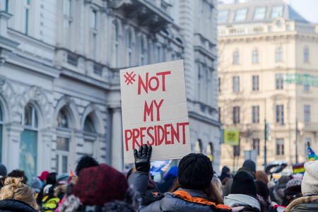 VIENNA, AUSTRIA - 21ST JAN 2017. Large amounts of people and a #NOT MY PRESIDENT  sign at a protest in Vienna over Donald Trumps presidencyのeditorial素材