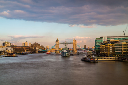 LONDON, UK - 11TH MARCH 2015:  A view towards Tower Bridge at sunrise across the River Thames. HMS Belfast can be seen in front of it.のeditorial素材