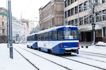 RIGA, LATVIA - 3RD JAN 2017: Trams in Riga during the day in the winter. Lots of snow can be seen.のeditorial素材