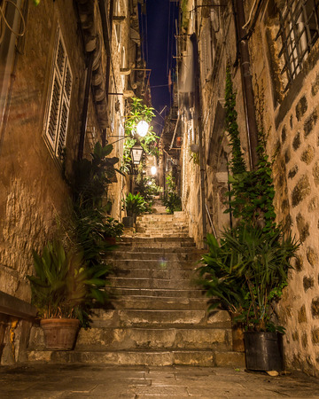 DUBROVNIK, CROATIA - 11TH AUGUST 2016: A view along streets of Dubrovnik at night. People and the outside of shops can be seen.のeditorial素材