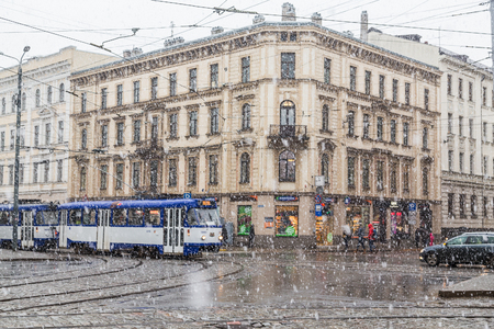 RIGA, LATVIA - 2ND JAN 2017:  Heavy snow falling in central Riga during the day in the winter. Buildings, vehicles and people can be seen.のeditorial素材