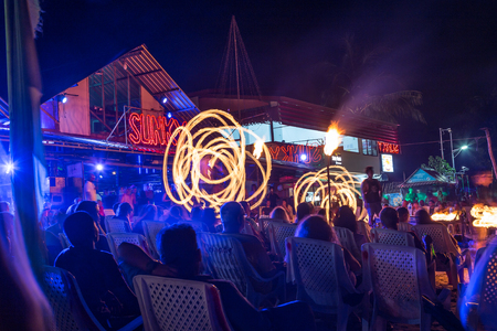 KO PHI PHI DON, THAILAND - 1ST APRIL 2017: Large groups of people on the beach in Ko Phi Phi Thailand watching fire dancers outside of bars and clubs.のeditorial素材