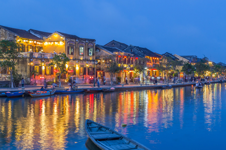 HOI AN, VIETNAM - 24TH MARCH 2017: A view over the  Thu Bon River towards Bach Dang street in Ancient Town. Colourful lights, buildings, reflections and people can be seen.のeditorial素材