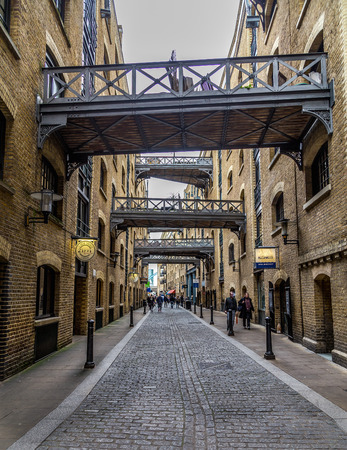LONDON, UK - 8TH MARCH 2015: A view along the Shad Thames street near Tower Bridge in London during the day. People and the outside of shops can be seen.のeditorial素材