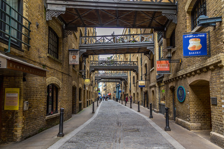 LONDON, UK - 8TH MARCH 2015: A view along the Shad Thames street near Tower Bridge in London during the day. People and the outside of shops can be seen.のeditorial素材