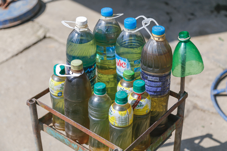 SAPA, VIETNAM - 22ND MARCH 2017: Various bottles containing gasoline outside a shop in Sapa Vietnam. This is a common way that fuel is presented to patrons in this region.のeditorial素材