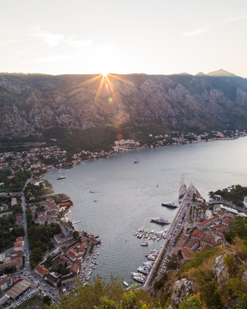 KOTOR, MONTENEGRO - 12TH AUGUST 2016: A view of the Kotor Skyline in Montenegro at sunset. Showing buildings, mountains and boatsのeditorial素材