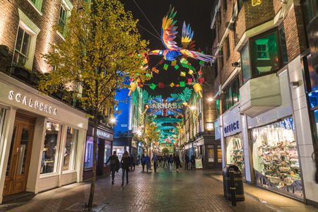 LONDON, UK - 13TH DECEMBER 2017: A view along Carnaby Street in London at night at Christmas. Lots of colorful decorations can be seen.のeditorial素材
