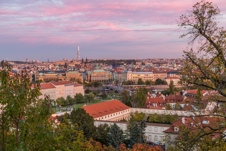 A view of the Prague skyline at sunset. Lots of buildings can be seen as well as a colourful sky.の写真素材