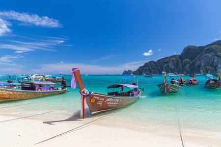 KO PHI PHI, THAILAND, 31ST MARCH 2017: Long-tail boats, the Andaman Sea and hills in Ko Phi Phi Don, South Thailand. Clear blue water can be seen.のeditorial素材