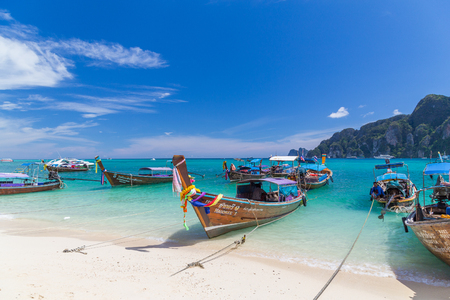 KO PHI PHI, THAILAND, 31ST MARCH 2017: Long-tail boats, the Andaman Sea and hills in Ko Phi Phi Don, South Thailand. Clear blue water can be seen.のeditorial素材